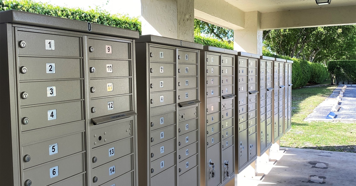 Several mailbox units installed in a row. The units sit on a covered outdoor entryway.