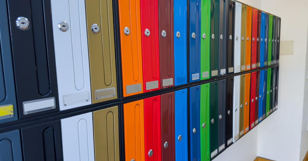 There are two rows and several columns of mailboxes; the mailboxes are all in different colors.